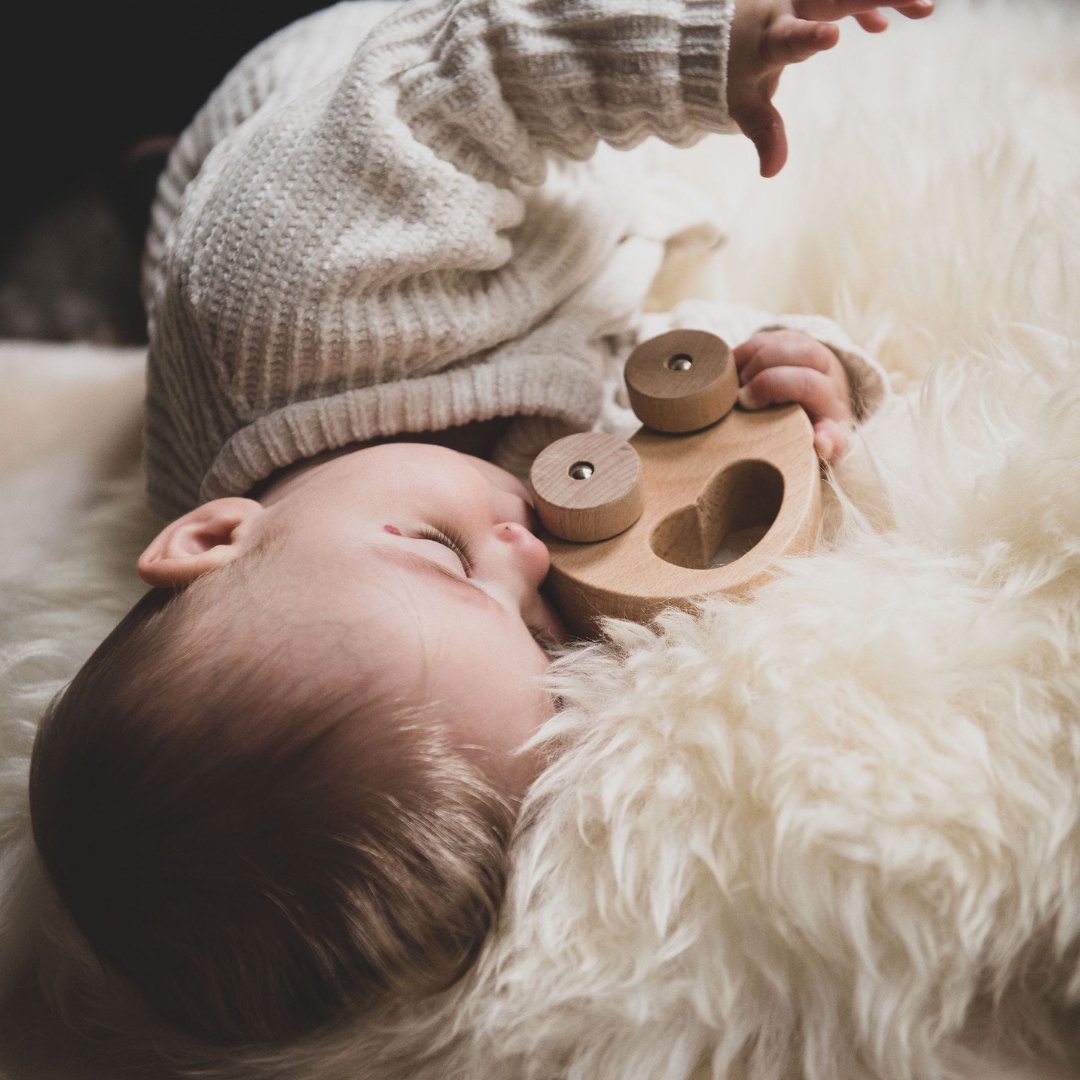 baby on sheepskin pram liner 