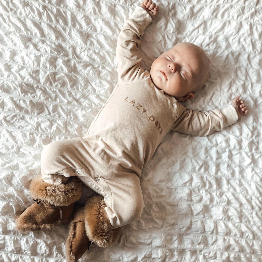 baby wearing sheepskin booties sleeping