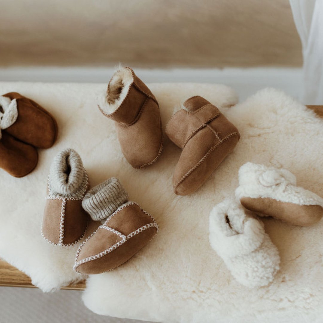 newborn baby booties in a basket