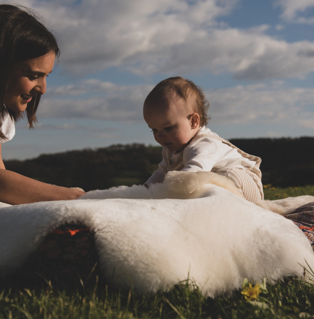 Sheepskin rug for baby and toddler to be used in the nursery for tummy time or outdoors in a soft cream and milk shade lambskin