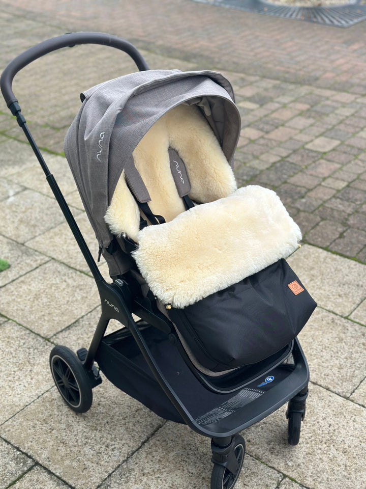 Sheepskin pram footmuff fitted in the Nuna Triv to keep baby cosy and snuggly in the cold winter months.