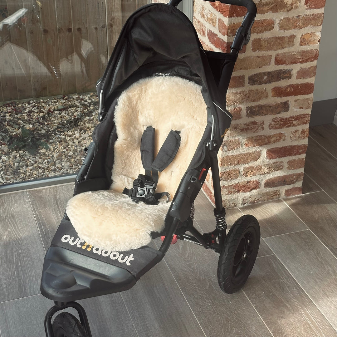 Sheepskin buggy liner in the out n about pram