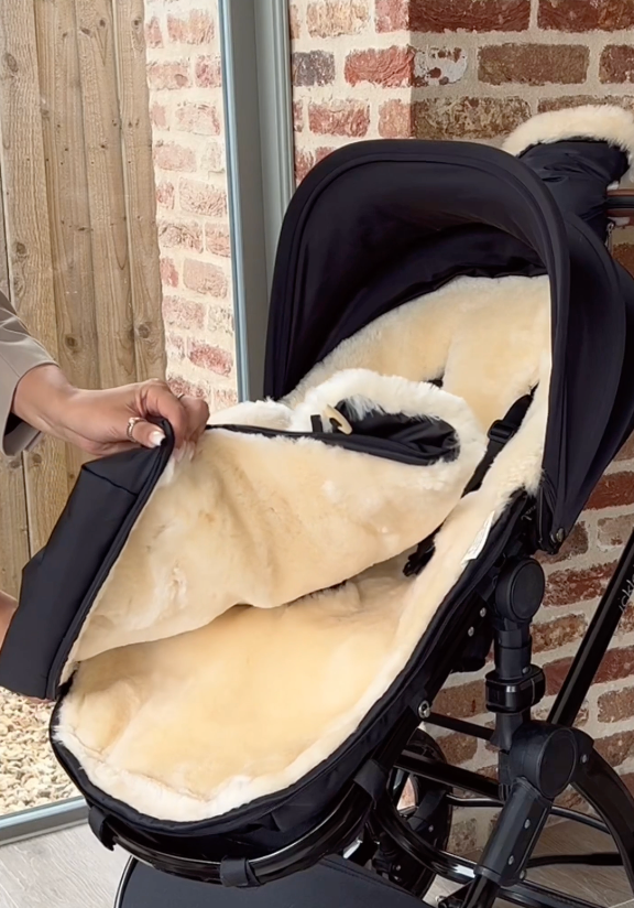 Image showing a sheepskin footmuff with the top being zipped off to leave a pram liner in the warmer months to use all year round