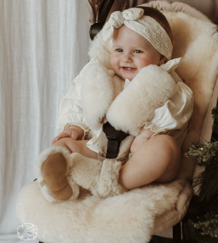 Sheepskin pram liner milk with harness covers shown in yoyo