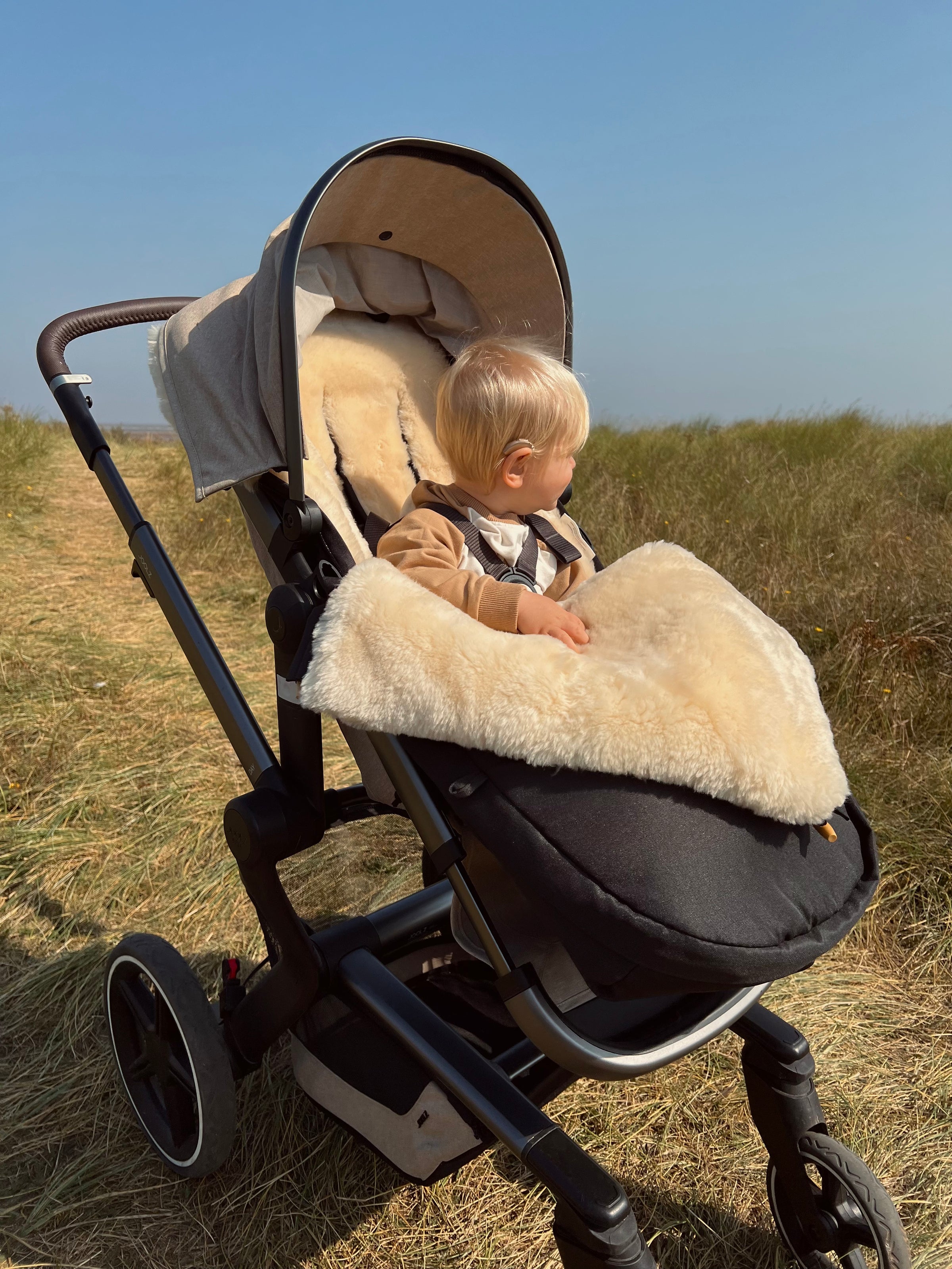 Luxurious sheepskin pram footmuff breathable and sustainable keeping your baby warm in the winter