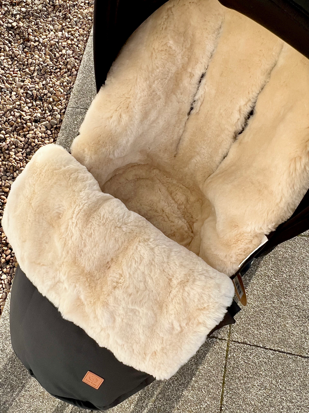 Baa Baby Luxury sheepskin footmuff with seat shaping to prevent the footmuff from slipping in the pram