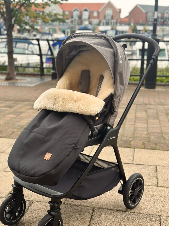 Nuna City Pram with a sheepskin footmuff fitted to provide warmth and comfort and soothe baby on walks