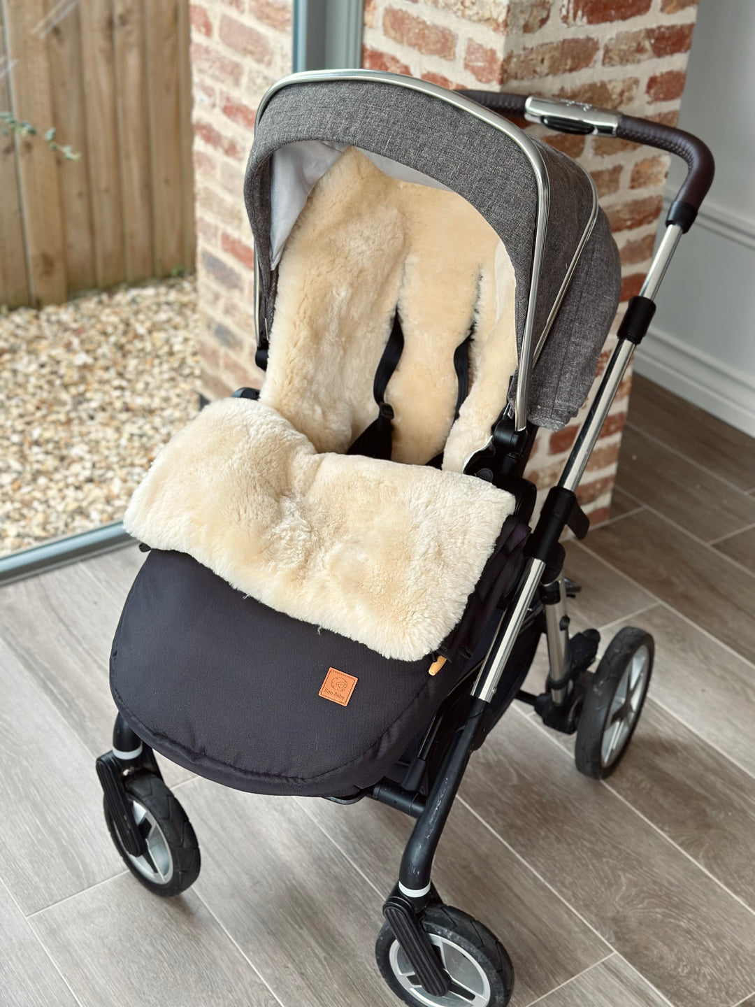 sheepskin pram footmuff shown in the silver cross pioneer or dune used to keep the baby warm in the winter