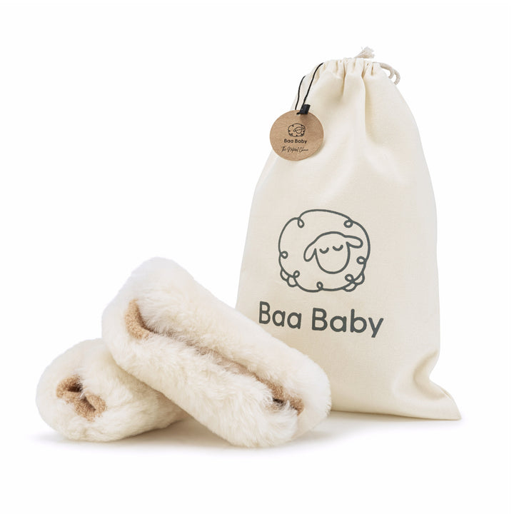 Sheepskin pram harness covers in neutral cream with a gift bag