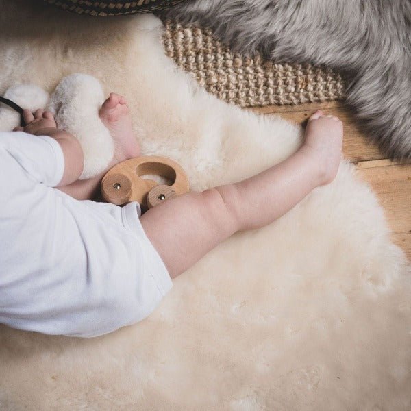 Shorn Lambskin Baby Rug for Nursery Neutral Decor, with baby sitting on it