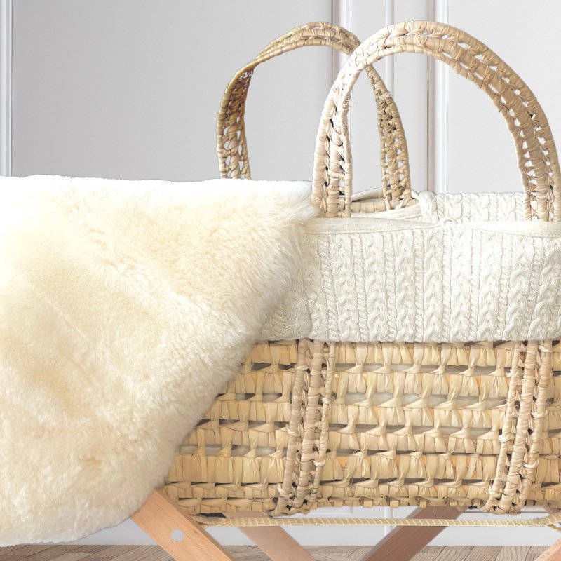 Sheepskin carrycot liner to settle a newborn baby placed in a moses basket