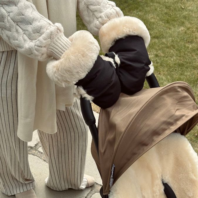 sheepskin lined pram mittens on the handles of a babyzen yoyo pram to keep mum warm in winter