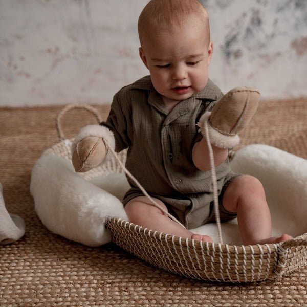 Chestnut coloured mittens on string for babies with a sheepskin lining