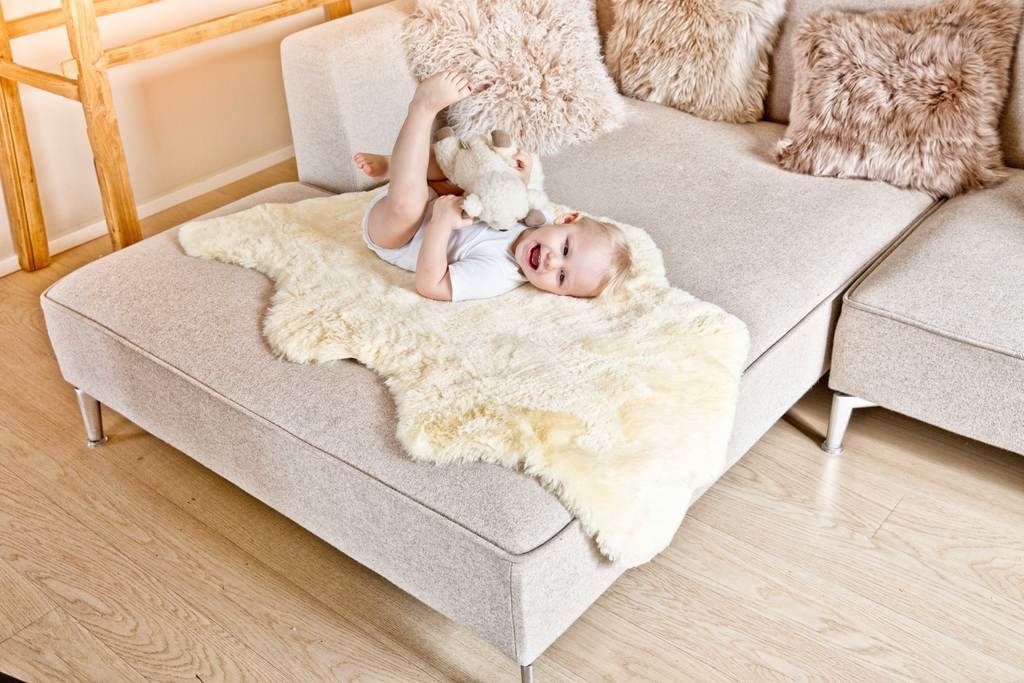 Baby Tummy Time and Sleep Shown on Fellhof Pale Honey Sheepskin