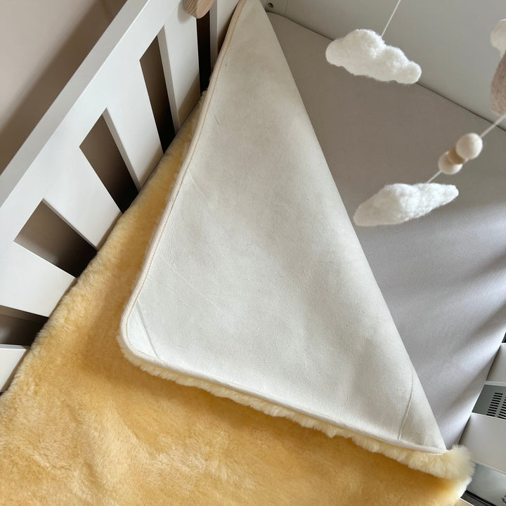 Heitmann Felle sheepskin mattress cover and cot bed topper in size for a cot or a junior bed