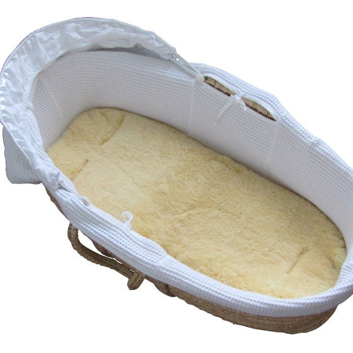 Heitmann Felle Honey Lambskin Liner Shown in Moses Basket with Dense Pile for Even Weight Distribution.  Sheepskin keeps baby warm in winter and cool in summer and a sheepskin liner helps newborns sleep