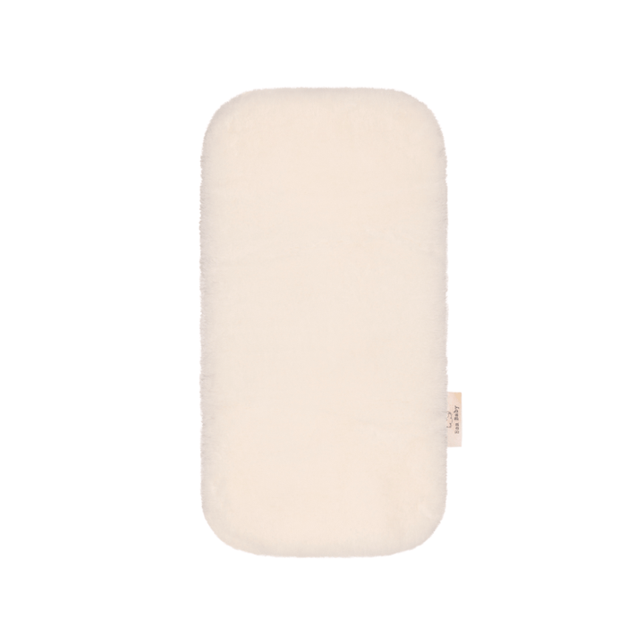 Baa Baby bassinet liner in a creamy milk colour
