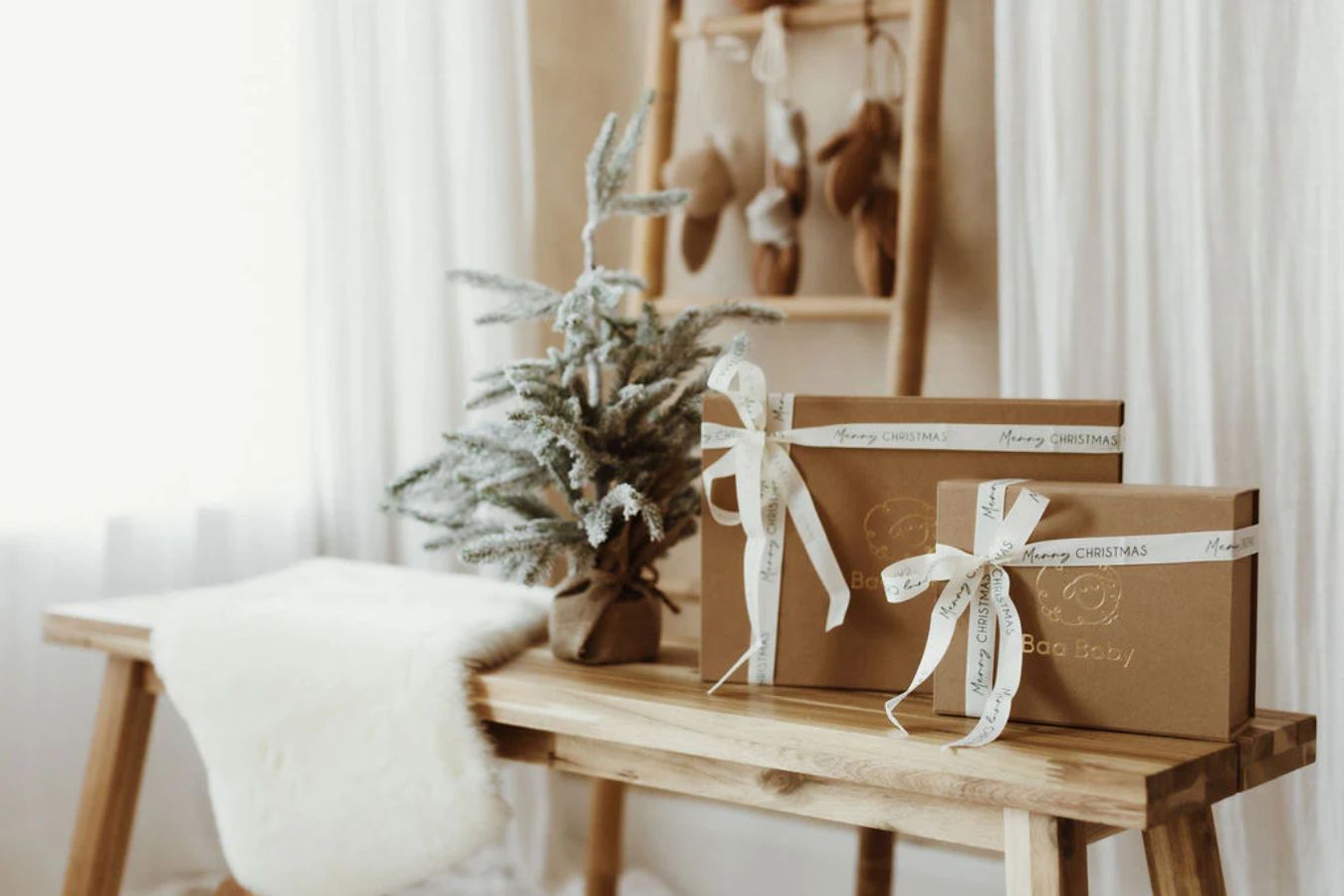 Baa Baby newborn gift boxes for standing on a table near small Christmas tree