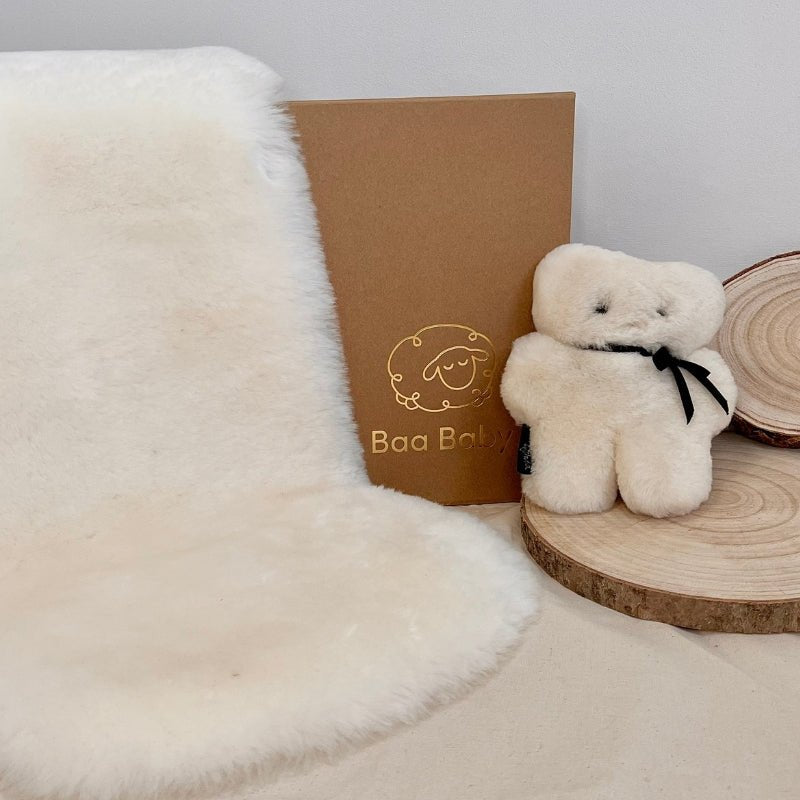 Luxury Ivory Sheepskin for Baby Gifting, a ready made baby shower gift consisting of a pale white sheepskin liner for a carrycot or moses basket and a sheepskin flatout bear