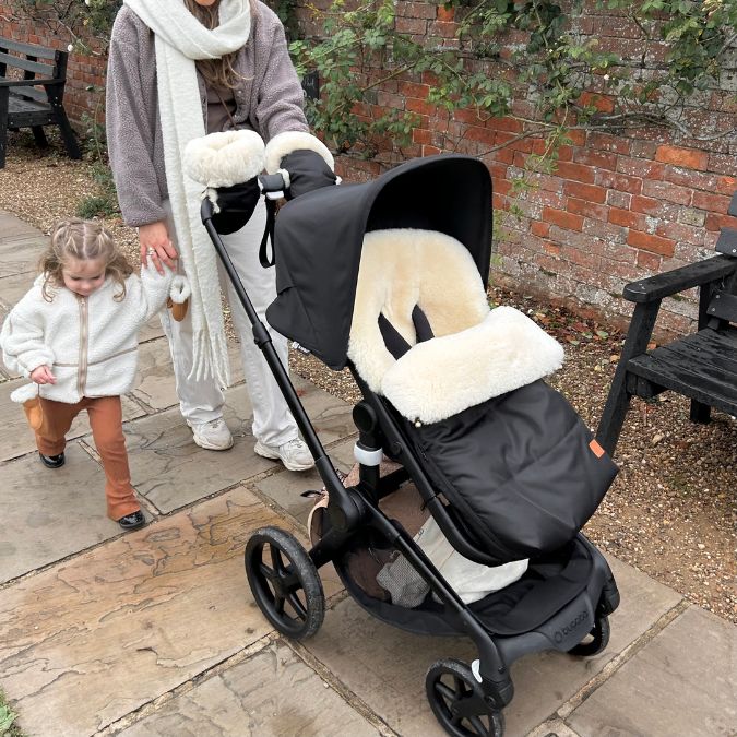 luxury baa baby sheepskin pram mittens on a bugaboo box 5 to keep mum and baby warm in winter
