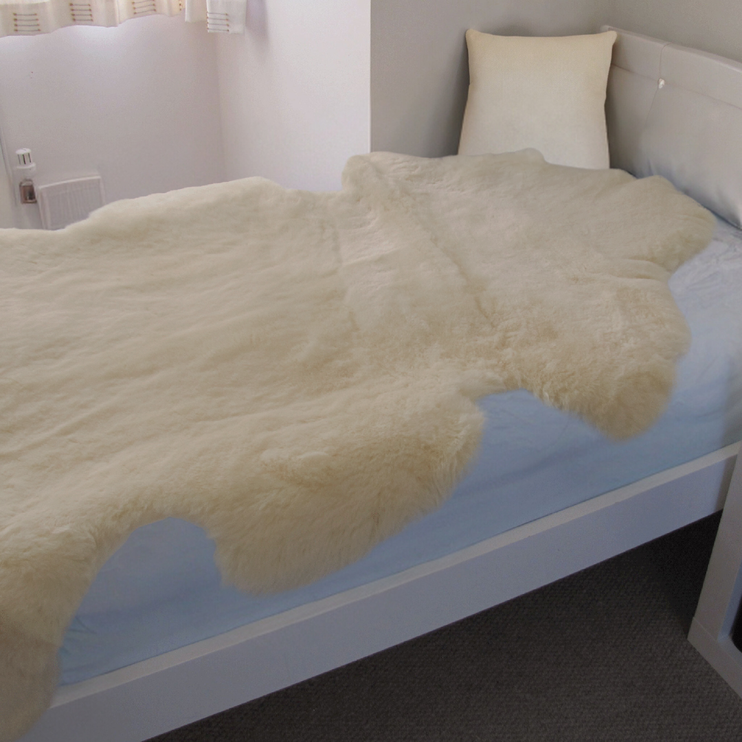 sheepskin medical grade pale cream colour laid on a bed to help a toddler or baby sleep