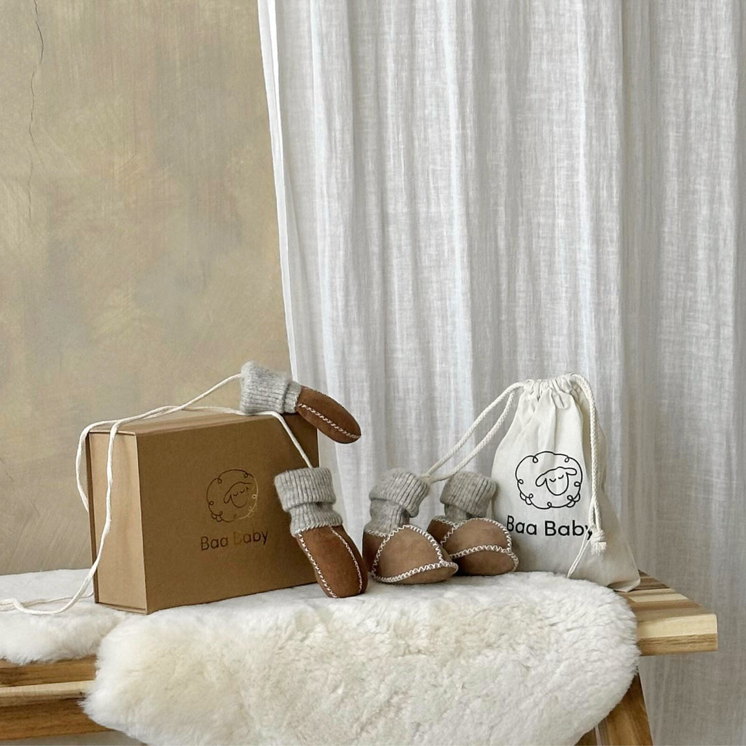 Luxury baby gift set with merino sheepskin sock booties and puddy mittens on string in a neutral beige colour in a keepsake gift box 