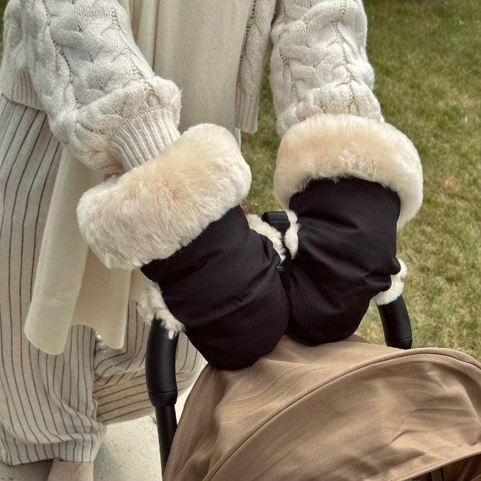 parent wearing pram gloves while pushing buggy 