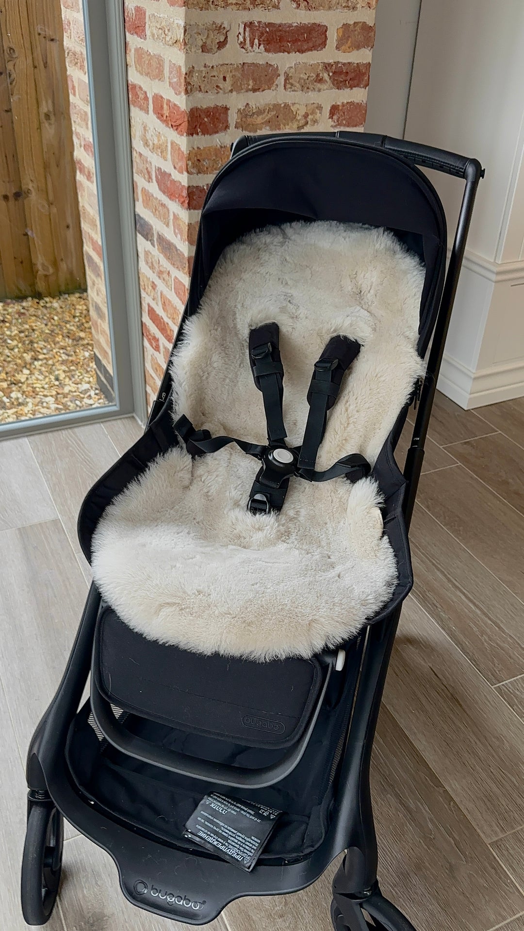 Sheepskin pram style liner in latte fitted in to a bugaboo dragonfly pram