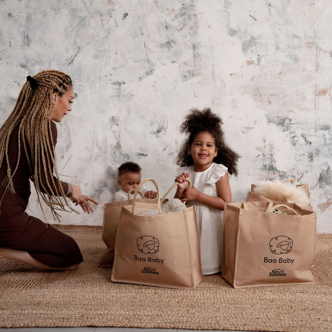 baby safe sheepskin rug and pram liner in a cotton and jute premium shopper bag