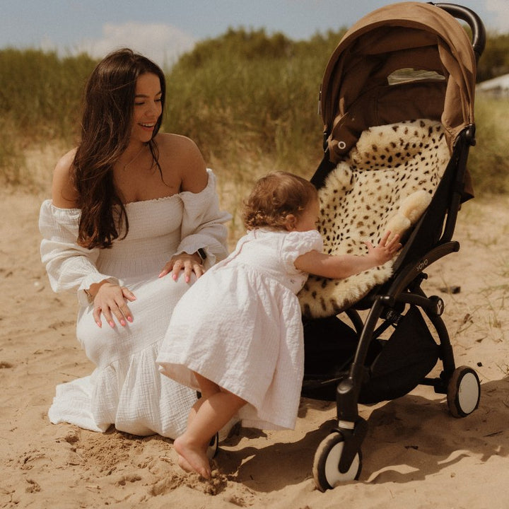 Sheepskin pram liner in the leopard print style in a yo yo pram