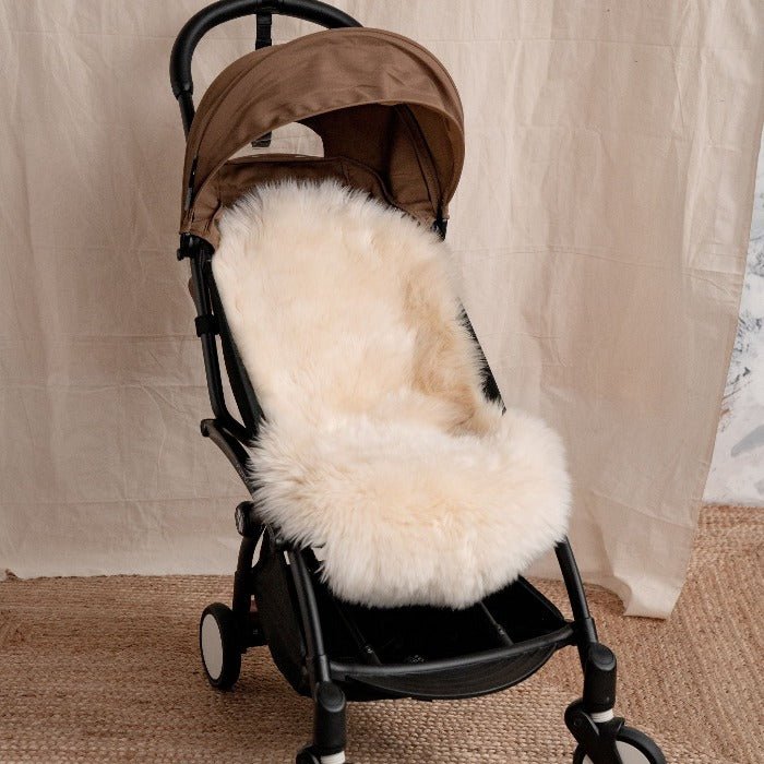 Neutral sheepskin pram liner for a 5 point harness