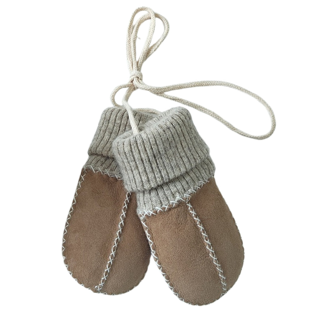 sock mittens for a baby or toddler with strings to keep safe and with a sock cuff made of merino.  Mittens are sheepskin lined with a suede outer and in a soft caramel brown and beige neutral shade