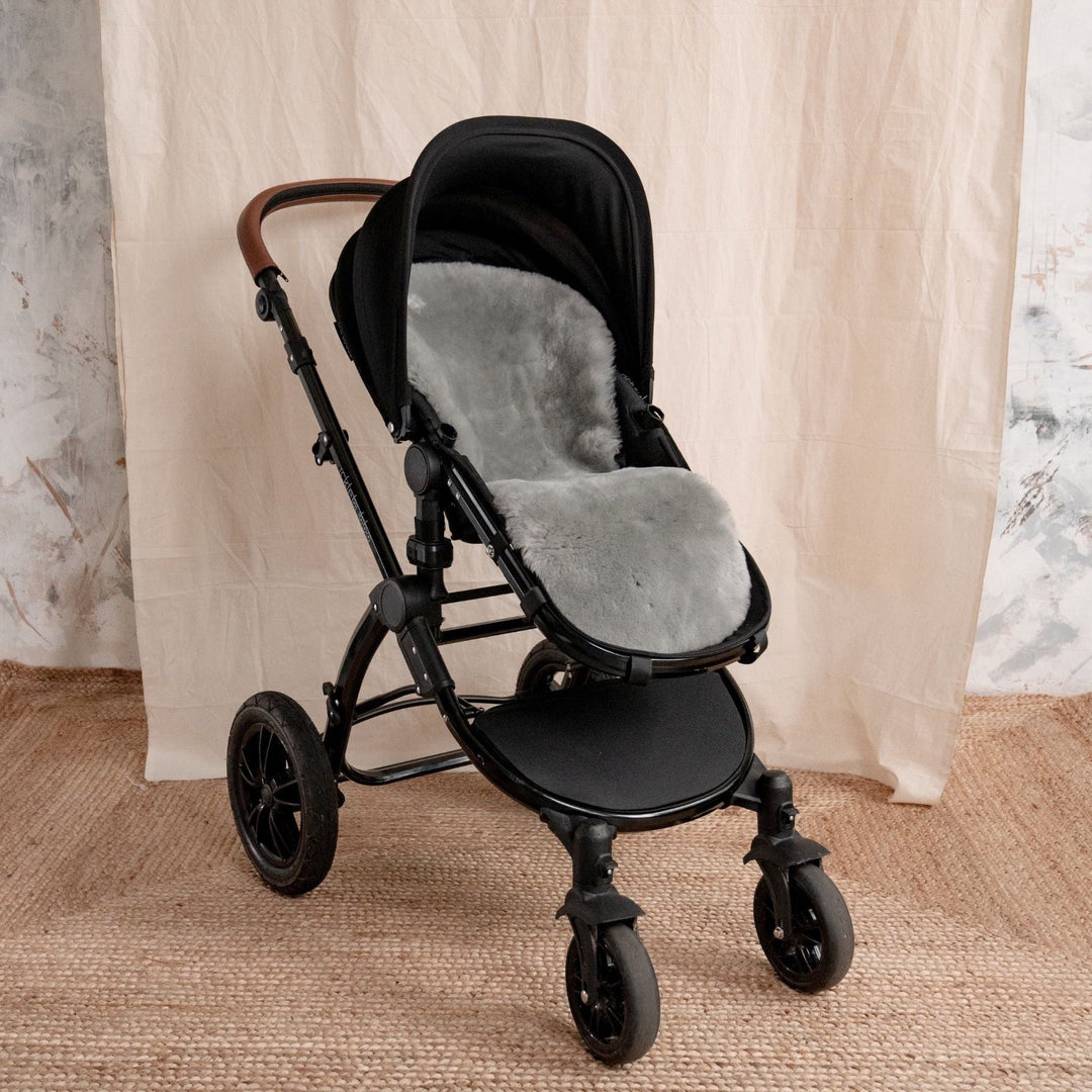 Grey buggy style sheepskin merino liner shown in and ickle bubble pram 